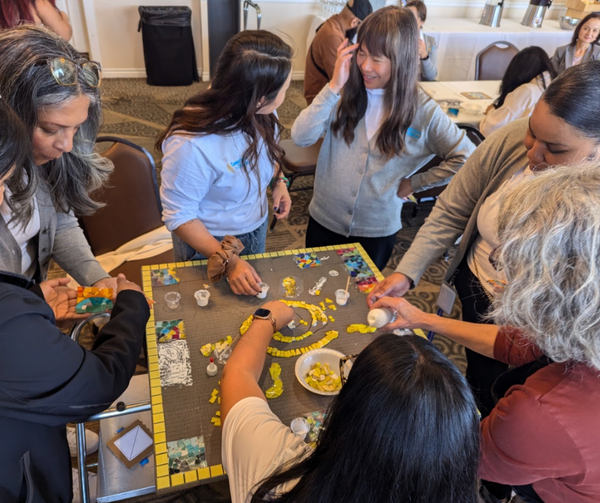 Piece by Piece team leading the Connections For Children team in creating mosaics.